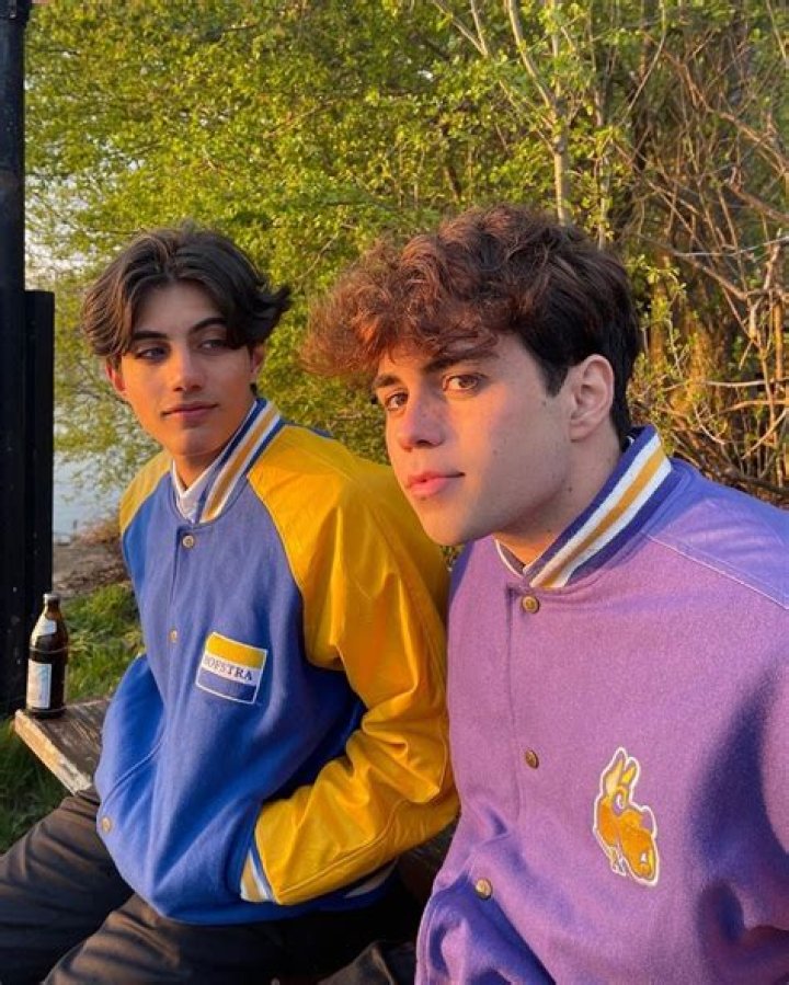 Nic Kauffmann (left) look at Benji Krol (right) with their hands in their jacket pockets.