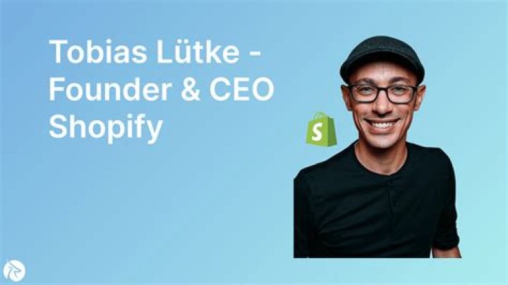Shopify CEO Tobi L&uuml;tke outside the New York Stock Exchange. A huge green board with Shopify written on it is displayed behind him.