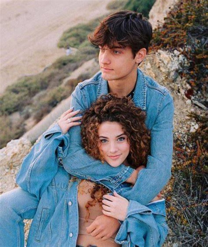 Sofie Dossi and her boyfriend Dom Brack kissing in front of the Disneyland Palace during an evening date.
